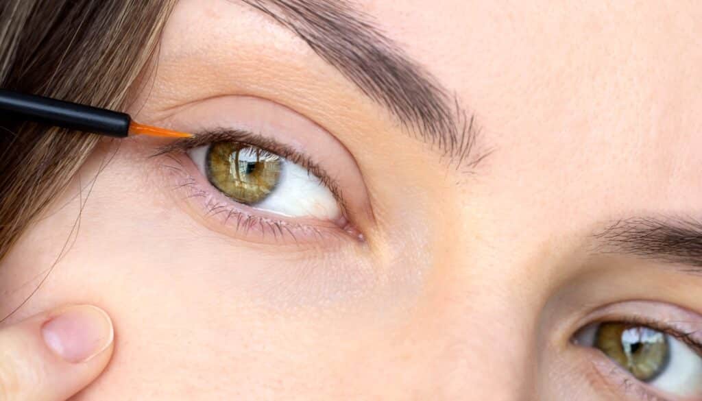 woman applying latisse eyelash serum
