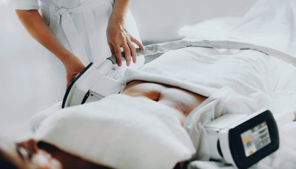 woman hooked up to coolsculpting machine