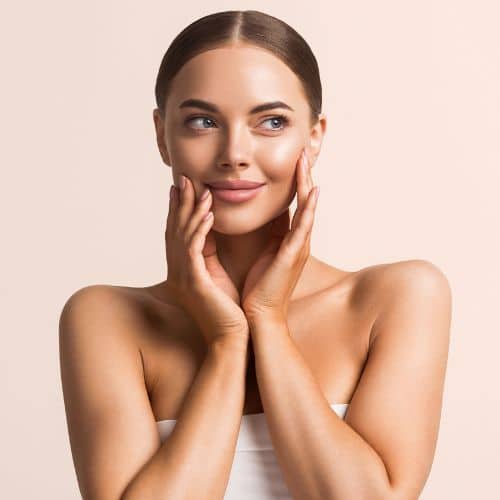 woman face with hands touching skin